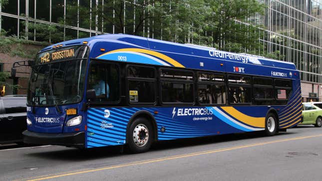 A blue electric bus driving through New York City