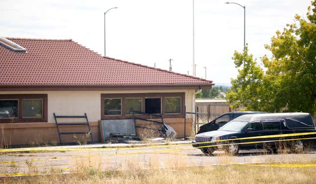 FILE - A hearse and van sit outside the Return to Nature Funeral Home, Oct. 6, 2023, in Penrose, Colo. Jon and Carie Halfford, who are accused of storing 200 decaying bodies and sending families fake ashes last year, are set to enter pleas in court on Thursday, March 21, 2024. (AP Photo/David Zalubowski, File)