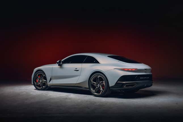 A very expensive gray coupe lurks extra lurkfully in front of a blood-colored background. Spooky!