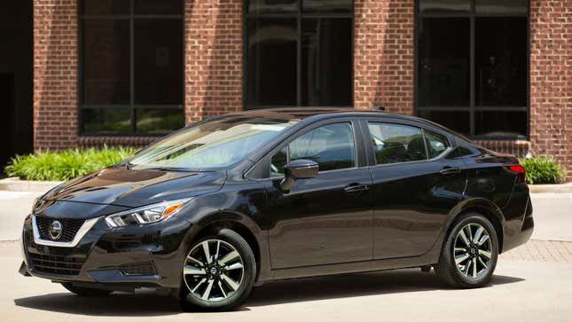 A photo of a black Nissan Versa sedan. 