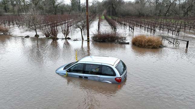 In an aerial view, a car is submerged in floodwater after heavy rain moved through the area on January 09, 2023 in Windsor, California. 