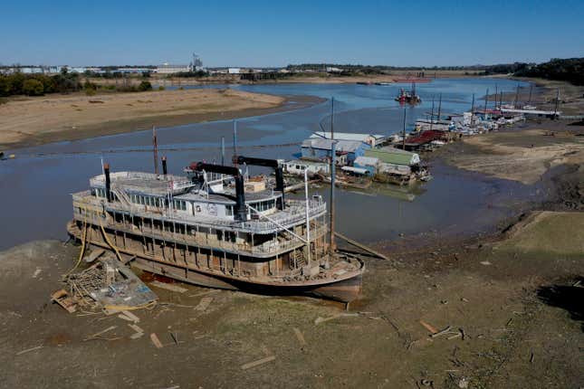 The Diamond Lady, a once majestic riverboat, rests with smaller boats in mud at Riverside Park Marina in Martin Luther King Jr. Riverside Park along the Mississippi River on October 19, 2022 in Memphis, Tennessee. Lack of rain in the Ohio River Valley and along the Upper Mississippi has the Mississippi River south of the confluence of the Ohio River nearing record low levels which is wreaking havoc at marinas, and with barge traffic, driving up shipping prices and threatening crop exports and fertilizer shipments as the soybean and corn harvest gets into full swing.