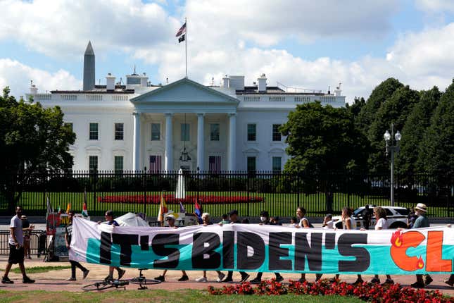 FILE - Climate activists rally in front of the White House at Lafayette Square to demand that President Joe Biden declare a climate emergency and move the country rapidly away from fossil fuels, July 4, 2023, in Washington. After being thwarted by Congress, Biden will use his executive authority to create a New Deal-style American Climate Corps that will serve as a major green jobs training program. (AP Photo/Yuri Gripas, File)