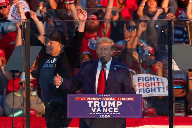 Tesla CEO Elon Musk cheers behind Former President Donald Trump during a campaign rally at the Butler Farm Show fairgrounds on October 05, 2024 in Butler, Pennsylvania. 