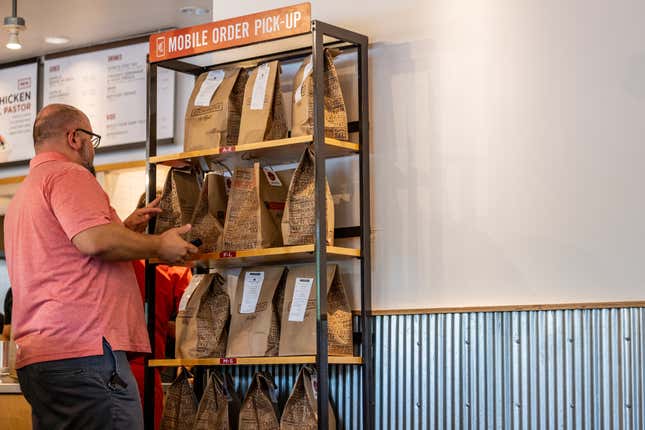 A customer searchers for their mobile order pick-up at a Chipotle Mexican Grill restaurant on April 26, 2023 in Austin, Texas.