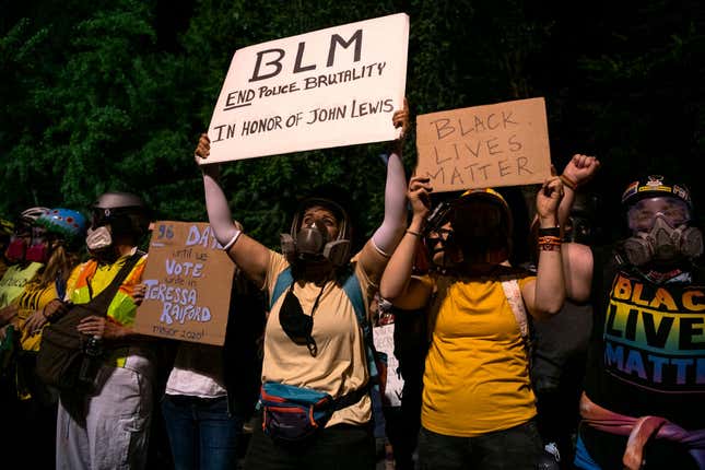 Women with the Moms United for Black Lives Matter, formerly called Wall of Moms, line up outside the Mark O. Hatfield Federal Courthouse during a night of protest against racial injustice, police brutality, and the deployment of federal troops to US cities on July 29, 2020, in Portland, Oregon.