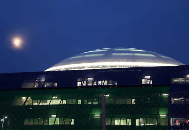 The moon rises over the illuminated library of the University of Cyprus in Nicosia.