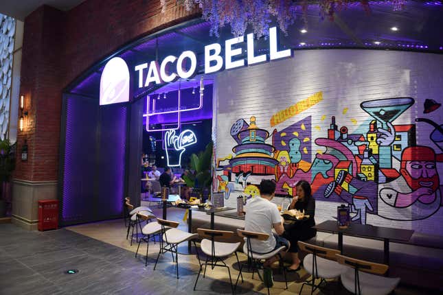 People eat at a Taco Bell in Beijing, China. 