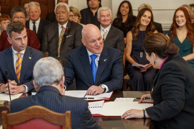 New Zealand Prime Minister Christopher Luxon, center, talks with with Governor-General Dame Cindy Kiro during the swearing-in ceremony at Government House in Wellington, New Zealand, Monday, Nov. 27, 2023. Luxon, the 53-year-old former businessman, was officially sworn in as New Zealand&#39;s 42nd prime minister on Monday, and said his top priority was to improve the economy. (Mark Mitchell/New Zealand Herald via AP)