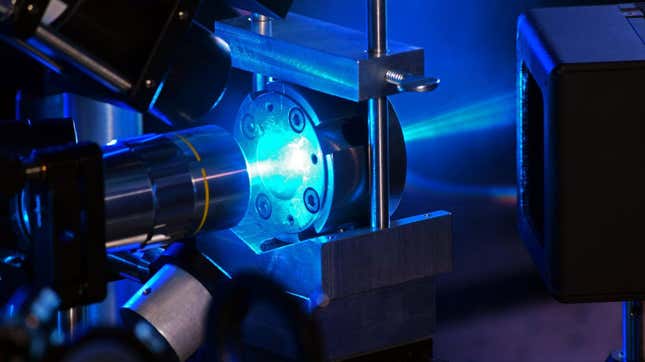 A bright blue laser light illuminates a sample.