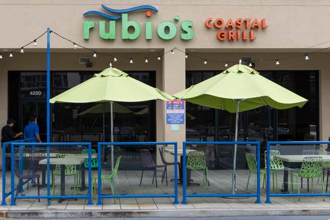 Passerby’s look in the windows of Rubio’s Costal Grill on Lincoln Blvd in Los Angeles, CA. 