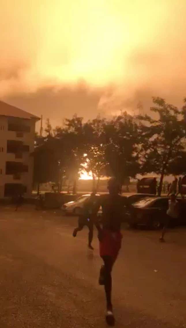People run after a natural gas station explodes in Accra.