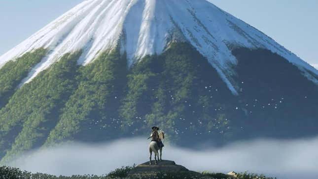 Atsu looks at a mountain while on horseback.