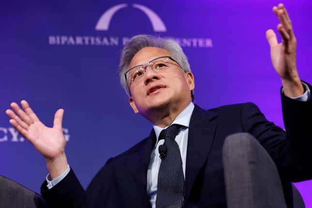 Jensen Huang speaking, looking upward, with his hands up, in front of a purple backdrop