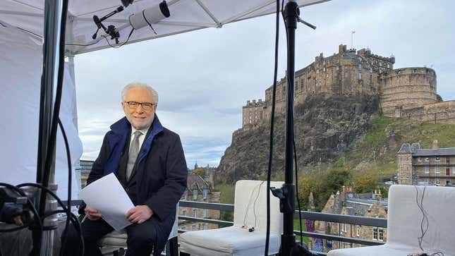 Wolf Blitzer sitting on the set in front of Edinburgh Castle, which is located 47 miles from Glasgow.
