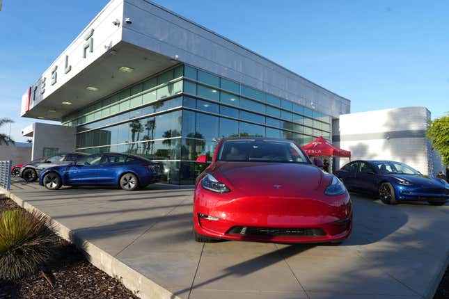A red Tesla Model Y at Tesla store and service center