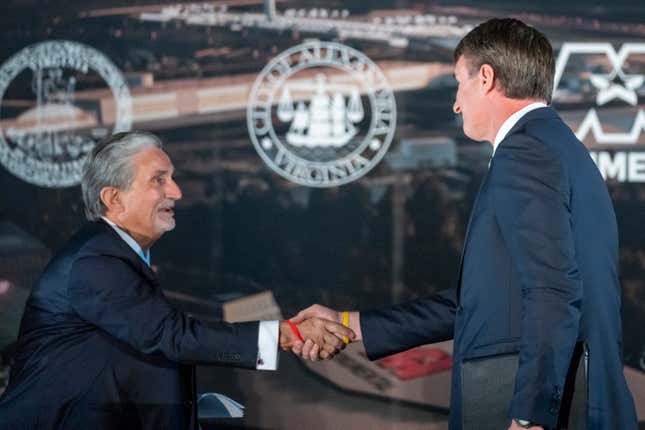 FILE - Ted Leonsis, left, owner of the Washington Wizards NBA basketball team and the Washington Capitals NHL hockey team, shakes hands with Virginia Gov. Glenn Youngkin as they announce plans for a new sports stadium for the teams, Dec. 13, 2023, in Alexandria, Va. Influential labor groups announced Tuesday, Feb. 20, 2024, that they are opposing efforts to move the two professional sports franchises from the nation&#39;s capital to northern Virginia, citing in part an apparent inability to reach a satisfactory deal for union workers on the construction projects. (AP Photo/Alex Brandon, File)