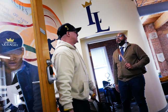 Ron Waddell, Founder and Executive Director of Legendary Legacies, right, talks with Gary Goyette at the nonprofit organization, Friday, April 19, 2024, in Worcester, Mass. Waddell credits Blue Cross Blue Shield volunteers for truly investing in their employee service opportunities, which are increasing across the corporate realm. (AP Photo/Charles Krupa)