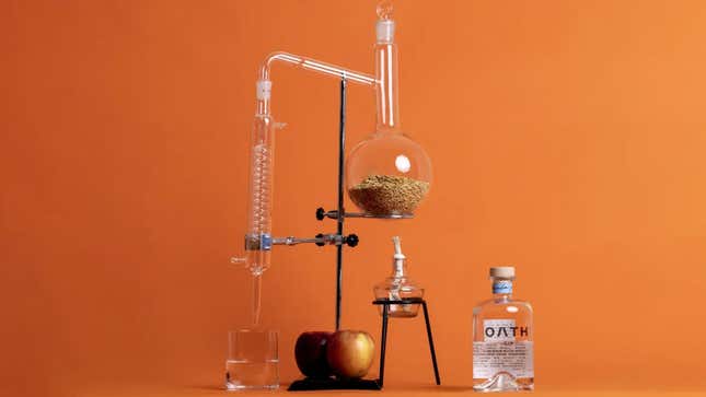 A photo of a bottle of Oath Gin next to some lab equipment. 