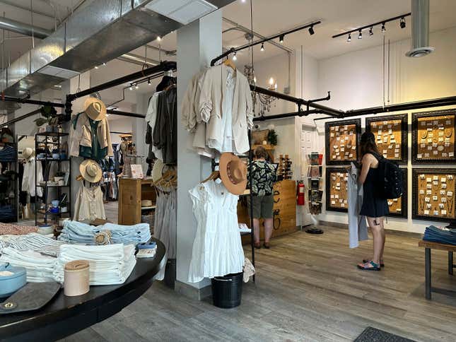 Shoppers wait to purchase items in a boutique on Tennyson Street Saturday, Aug. 5, 2023, in northwest Denver. On Thursday, the Commerce Department releases U.S. retail sales data for August.(AP Photo/David Zalubowski)