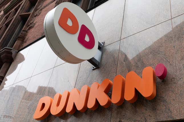 File - The Dunkin&#39; logo is seen on a storefront, Friday, Oct. 14, 2022, in Boston. A customer in central Florida has filed a negligence lawsuit against Dunkin&#39;, claiming he was injured from an exploding toilet at one of the coffee chain&#39;s locations. (AP Photo/Michael Dwyer, File)