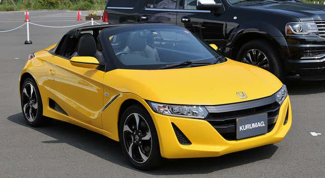 A yellow Honda S660.