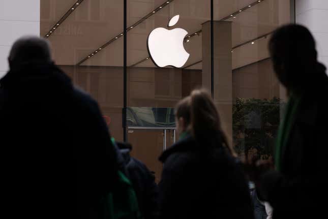 People walk past an Apple Store 