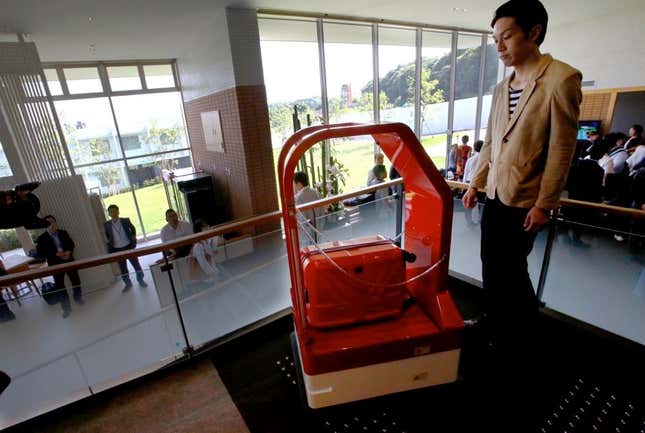 A porter robot escorts a human to a room.
