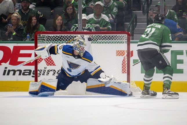 Oct 12, 2023; Dallas, Texas, USA; Dallas Stars left wing Jason Robertson (21) scores a goal against St. Louis Blues goaltender Jordan Binnington (50) during the overtime shootout period at the American Airlines Center.