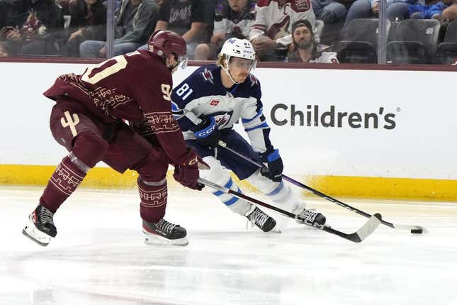 Nov 4, 2023; Tempe, Arizona, USA; Winnipeg Jets left wing Kyle Connor (81) skates around Arizona Coyotes defenseman J.J. Moser (90) in the third period at Mullett Arena.