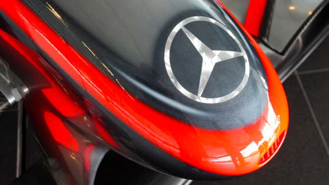 A photo of a Mercedes logo on the front of 2009 McLaren F1 car. 