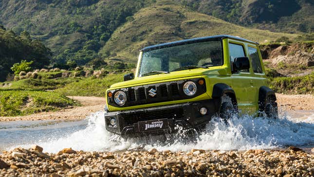 An image of a green Suzuki Jimny driving through a water splash