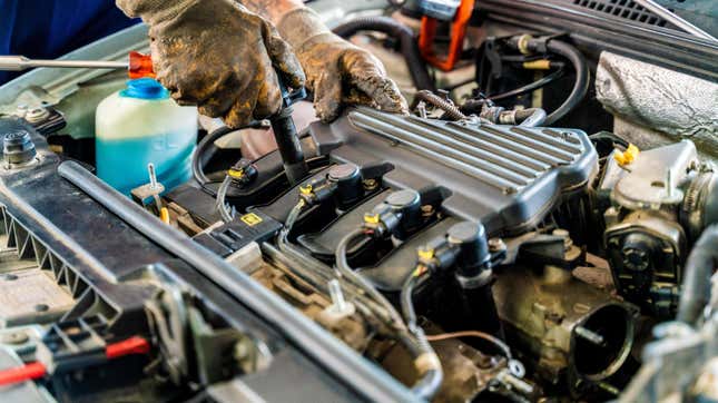 Professional mechanic working on the engine of the car in the garage