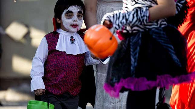 Small boy dressed as vampire trick-or-treating