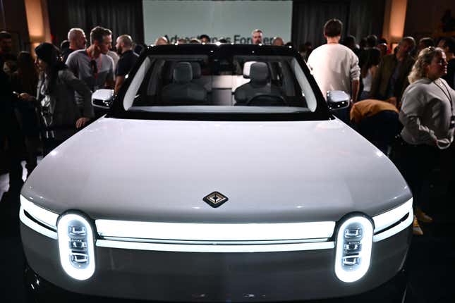 Attendees look at the new Rivian R2 electric vehicle at the Rivian South Coast Theater in Laguna Beach, California, on March 7, 2024.
