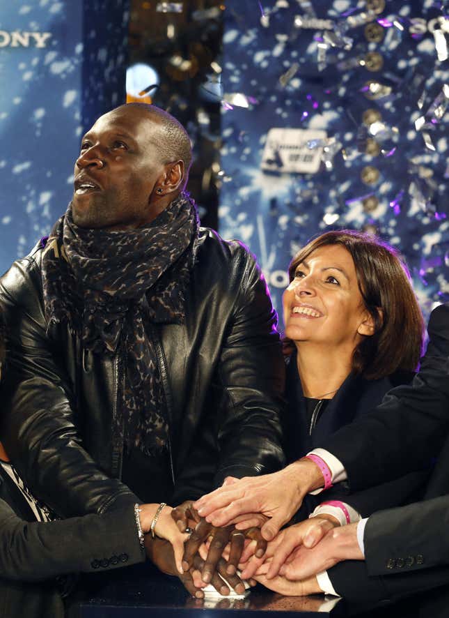Paris mayor Anne Hidalgo and actor Omar Sy switch on the Christmas lights on the Champs Elysees in Paris on Nov. 20, 2014.