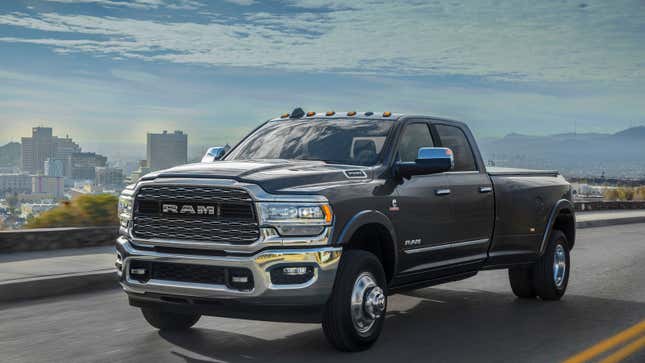 A photo of a gray RAM 3500 pickup truck with a city skyline in the background. 