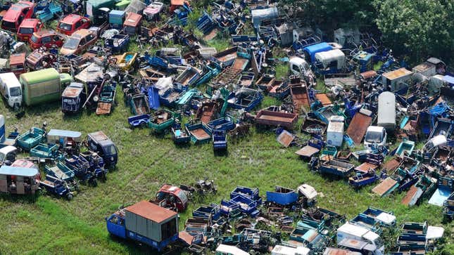 Ein Foto von einem Schrottplatz voller alter Autos. 