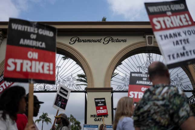 FILE - Demonstrators walk with signs during a rally outside the Paramount Pictures Studio in Los Angeles, Thursday, Sept. 21, 2023. A tentative deal was reached, Sunday, Sept. 24, 2023, to end Hollywood’s writers strike after nearly five months. (AP Photo/Jae C. Hong, File)