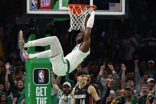 Oct 27, 2023; Boston, Massachusetts, USA; Boston Celtics guard Jaylen Brown (7) shouts out after dunking over Miami Heat guard Tyler Herro (14) during the second quarter at TD Garden.