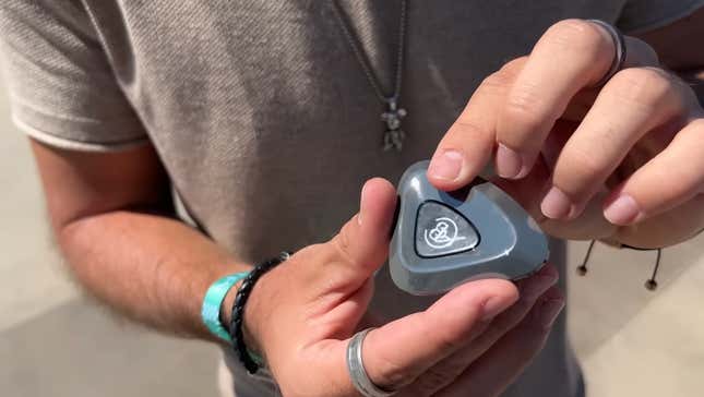 Lotus Eletre's small triangular "key" fob. It's triangular and looks like a pebble.