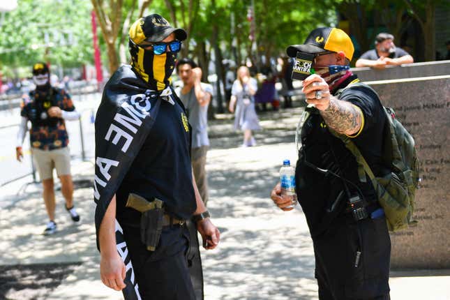 Counter-protesters wearing the yellow and black colors and insignia of the Proud Boys gather outside the National Rifle Association (NRA) Annual Meeting at the George R. Brown Convention Center in Houston, Texas, on May 28, 2022. - America’s powerful National Rifle Association kicked off a major convention in Houston Friday, days after the horrific massacre of children at a Texas elementary school, but a string of high-profile no-shows underscored deep unease at the timing of the gun lobby event.