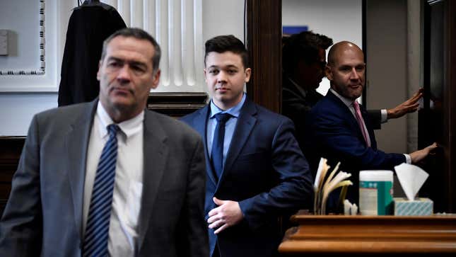 Kyle Rittenhouse, center, seen between attorneys Mark Richards, left, and Corey Chirafisi, right, as they enter a meeting in the Kenosha County Courthouse on Nov. 18, 2021.