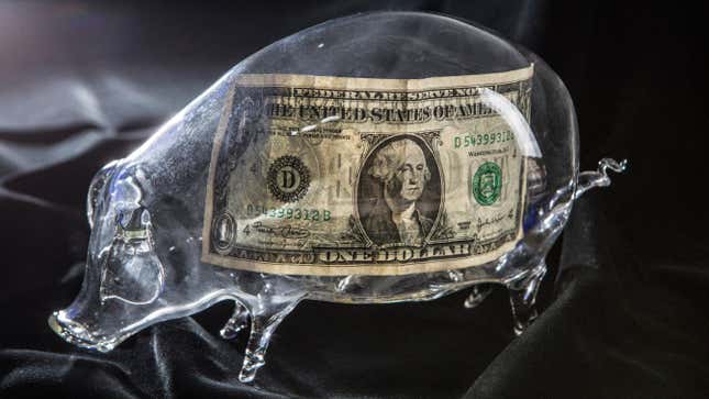 A one-dollar banknote in a glass piggy bank.