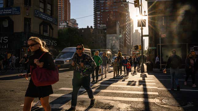 Pedestrians cross a street in New York City on October 12, 2022.