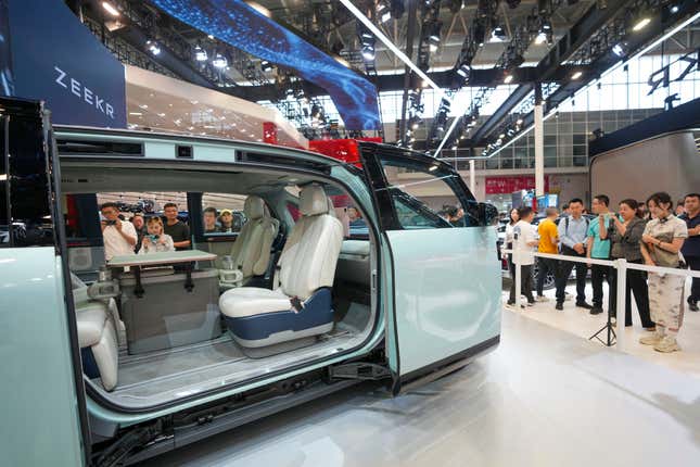 Visitors look at a Zeekr Mix car during the China Auto Show in Beijing, China, Friday, April 26, 2024. China&#39;s vision of the future of the automobile — electrified and digitally connected — is on display at the ongoing Beijing auto show. (AP Photo/Tatan Syuflana)