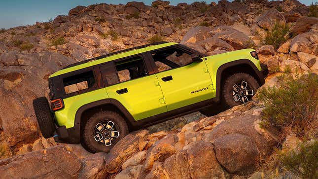 Side view of a Jeep Recon scaling rocks.