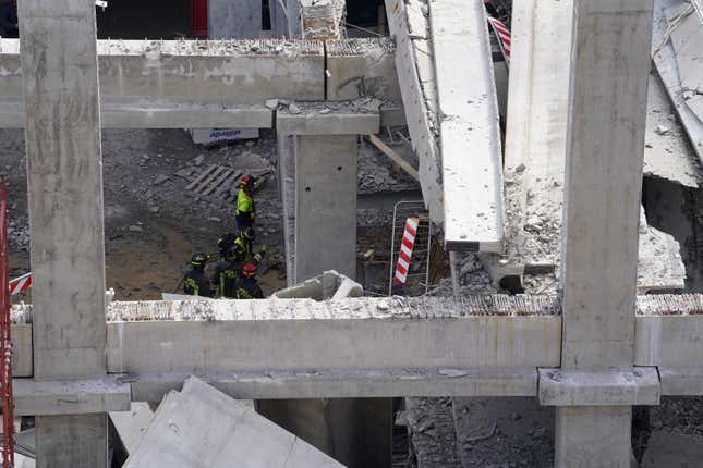 Firefighters arrive at the scene of an accident at a construction site in Florence, Italy, Friday Feb. 16, 2024. An accident at a supermarket construction site in the Italian city of Florence on Friday killed at least one worker and left four others missing, officials said. (Marco Bucco/LaPresse via AP)