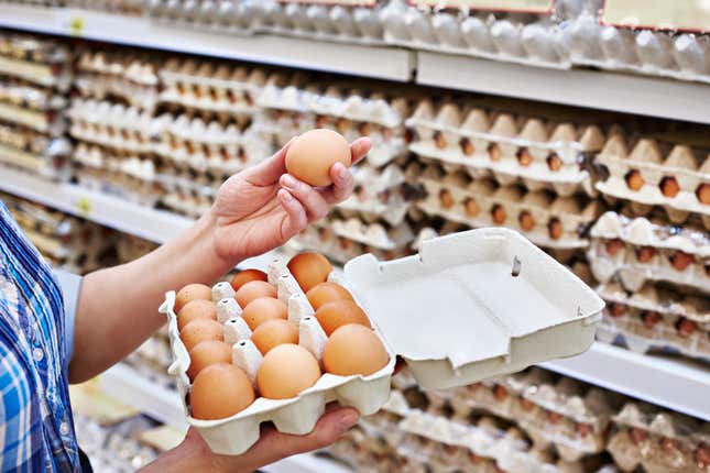 Hands of a woman packing eggs in the supermarket