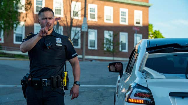 Officer helps at a traffic stop with a driver with an invalid license.